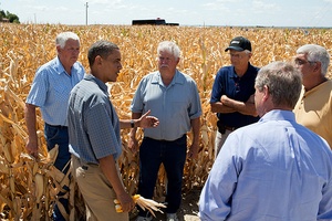 President Barack Obama speaking to a group of farmers in the midst of a corn field yellowed by drought