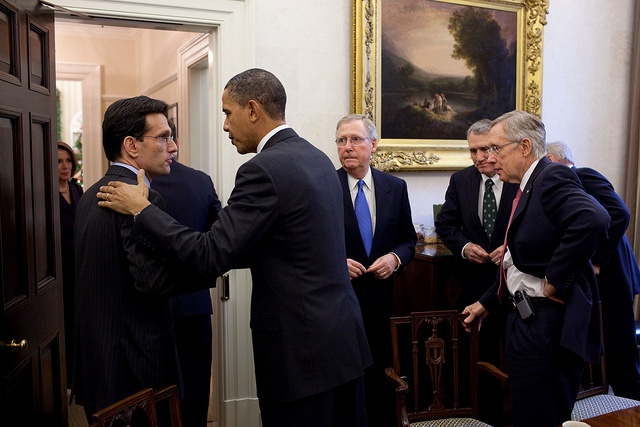 President Obama patting Eric Cantor on the back in a White House room as Sens. Mitch McConnell, Jon Kyl and Harry Reid look on.