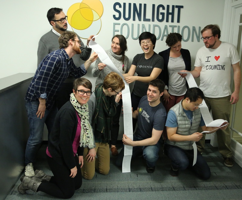 Sunlight Foundation staff examine the curiously long scroll of campaign finance data that came with Cards Against Humanity's gift on the ninth day of its 