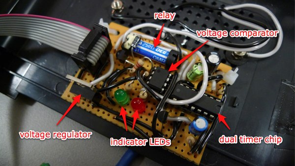 breakout board with labels for voltage comparator, 556 chip, relay, voltage regulator, etcetera. various capacitors, resistors, transistors and other components are also present but unlabeled