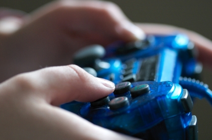 closeup photo of hands on a gaming console
