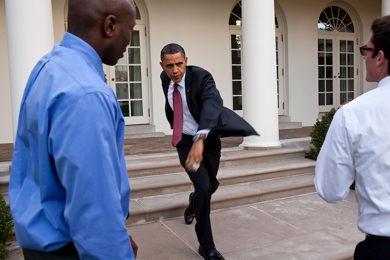 Photo of President Obama practicing a baseball pitch