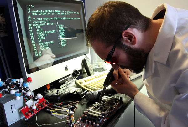 A Sunlight Foundation lab coat works diligently on the circuitry and advanced code behind the new Transparency Drone.