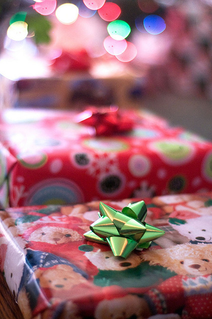 Photo of gift-wrapped packages with Christmas lights