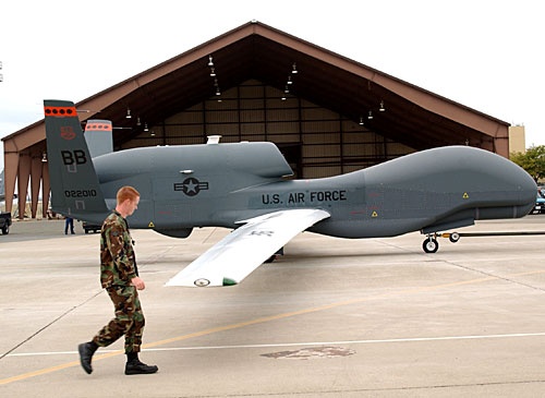 An Air Force officer walks past a Global Hawk unmanned aerial vehicle with U.S. Air Force markings