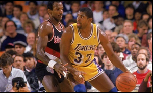 A picture of former NBA player Magic Johnson dribbling the ball