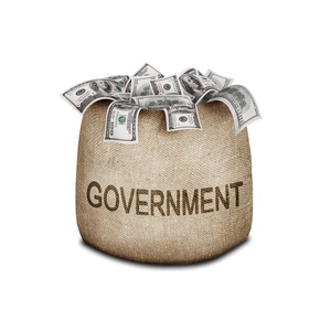 A burlap sack stuffed with money. The word Government is written on the sack. 