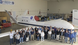NASA and Northrop Grumman workers stand in front of a Global Hawk, the unmanned aerial vehicle built by Northrop Grumman