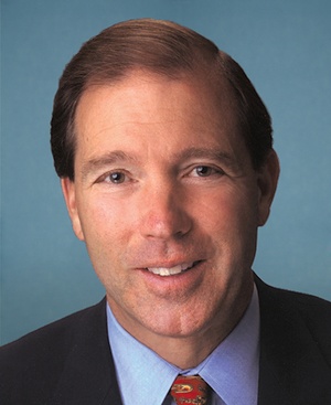 Head and shoulders shot of smiling man, light brown hair