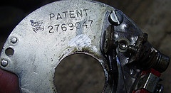 Doughnut shaped piece of metal equipment with patent number stamped on it