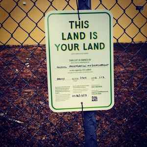 An image of a vacant lot in the Bronx. Sign design by Partner & Partners, printing by SmartSign. Photo by 596 Acres. 
