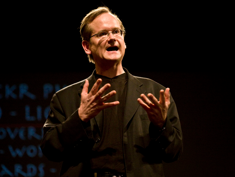 Professor Lawrence Lessig, in black suit, delivering a talk at Stanford