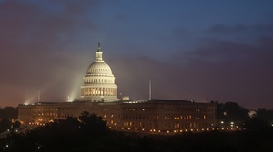 Photo of spotlit Capitol at dawn