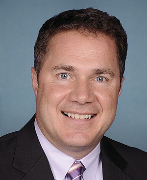 Closeup photo of Iowa Democratic Rep. Bruce Braley on blue background