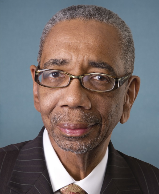 Rep. Bobby Rush, D-Ill.,  with glasses and black suit on blue background
