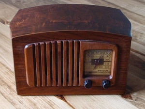 photo of old fashioned brown radio with clock and dials