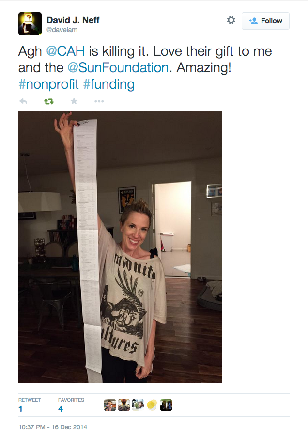 Tweet about Cards Against Humanity gift to Sunlight with picture of recipient holding long scroll of her senator's campaign contributions