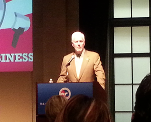 John Cornyn, in blazer standing at podium speaking at the U.S. Chamber of Commerce
