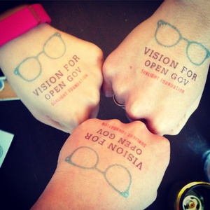 Three fists with Vision for Open Gov tatoos on them