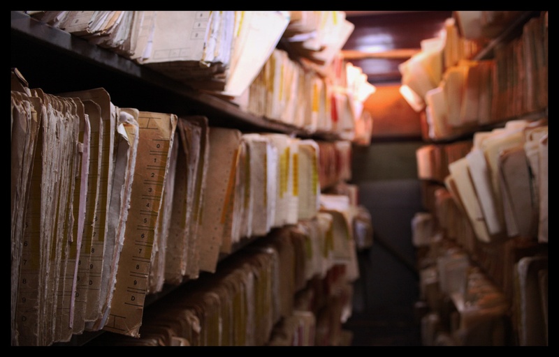 file folders filled with paper on shelves