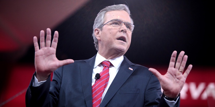 Jeb Bush speaking to a crowd with his hands up.