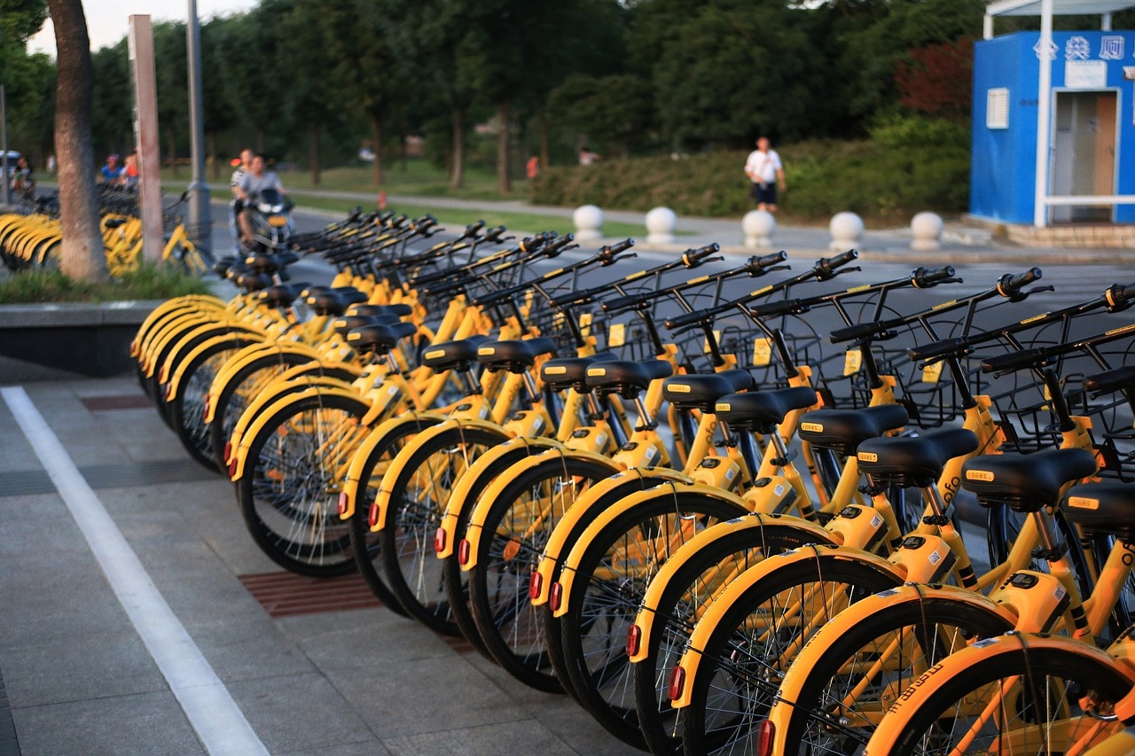 A row of yellow bike-sharing bikes.